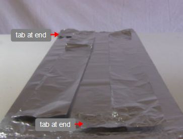 The two cut L-shaped aluminum foil pieces that will be plates
      for the electrolytic capacitor.