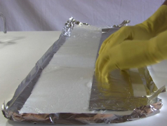 The 1st aluminum foil plate sitting on the electrolyte soaked
      paper towel.