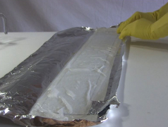 The paper towel soaked in electrolyte folded on the aluminum
      capacitor plate.